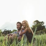 Loving couple sitting on grass field