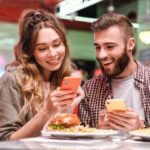 Loving couple using mobile phone.