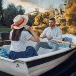 Love couple boating on lake at summer day