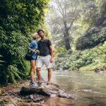 Loving couple standing by mountain stream