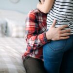 Portrait of young loving couple in bedroom