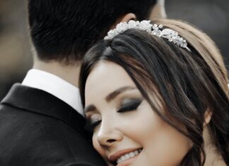 Naše mesto close up of smiling bride with her eyes closed hugging groom