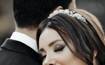 Naše mesto close up of smiling bride with her eyes closed hugging groom