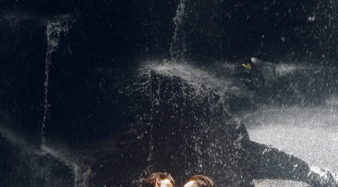 Žudim za tobom couple kissing on rock under waterfall