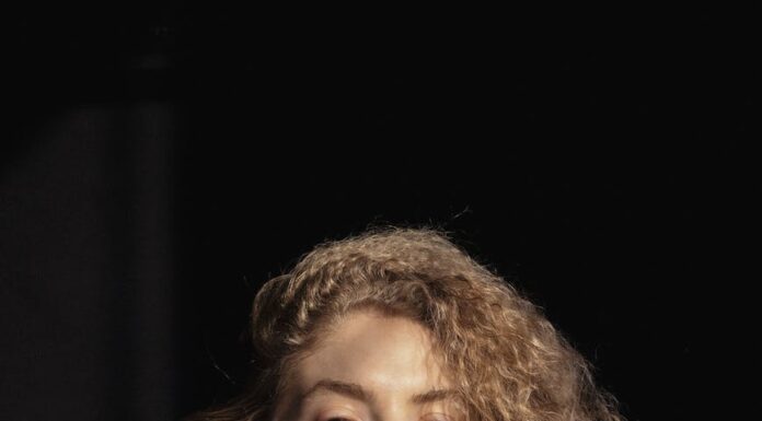 Seksualno ucenjena trendy young woman touching chin and looking at camera